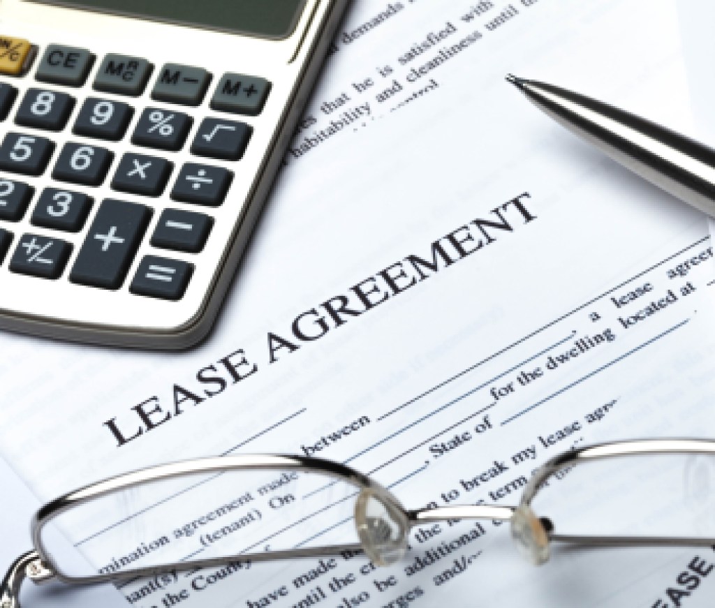 Lease Agreement Documents with Glasses, Pen and Calculator