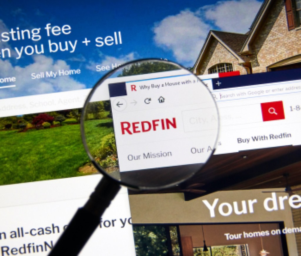 Redfin logo on official site under magnifying glass.